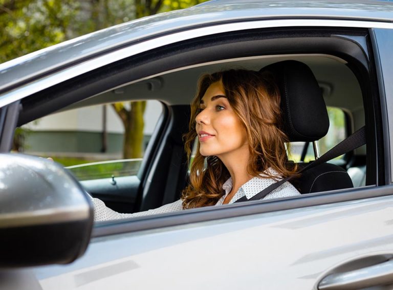 Woman driving a car with auto insurance in Bogart, GA