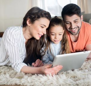 Family in Elberton, GA reviewing home insurance rates on a tablet